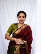 Woman in a traditional maroon and green Cotton Silk Maheshwari saree.